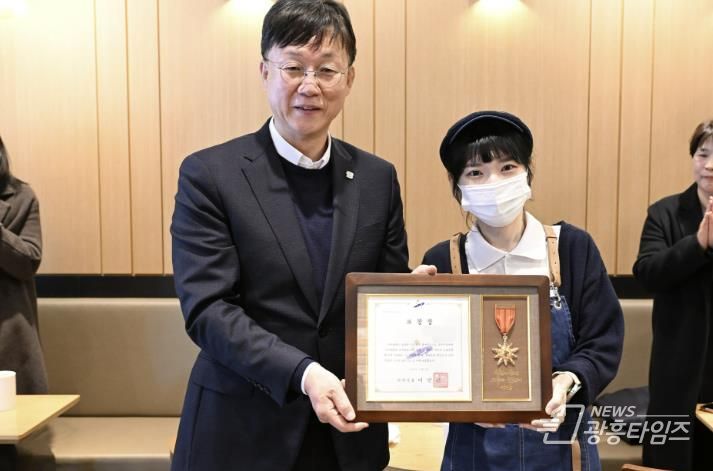 이민근 안산시장(왼쪽)이 지난달 수어로 고객에게 감동 전해 지역 사회에 선한 영향력을 끼친 커피점 점주에게 모범시민 표창을 수여하고 함께 기념촬영을 하고 있다.